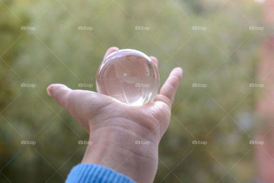 transparent globe in hand