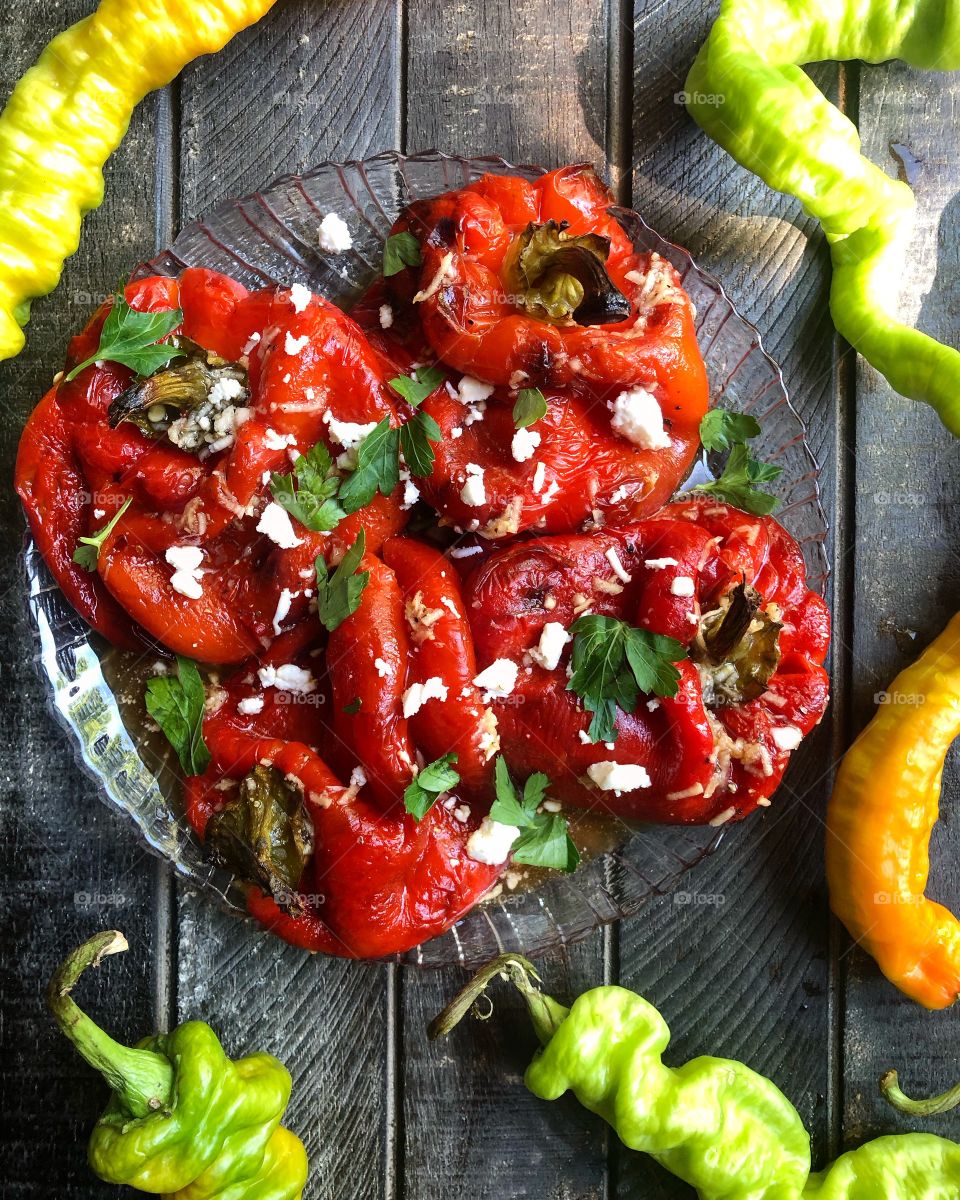 Grilled peppers in a zesty dressing topped with parsley and feta cheese