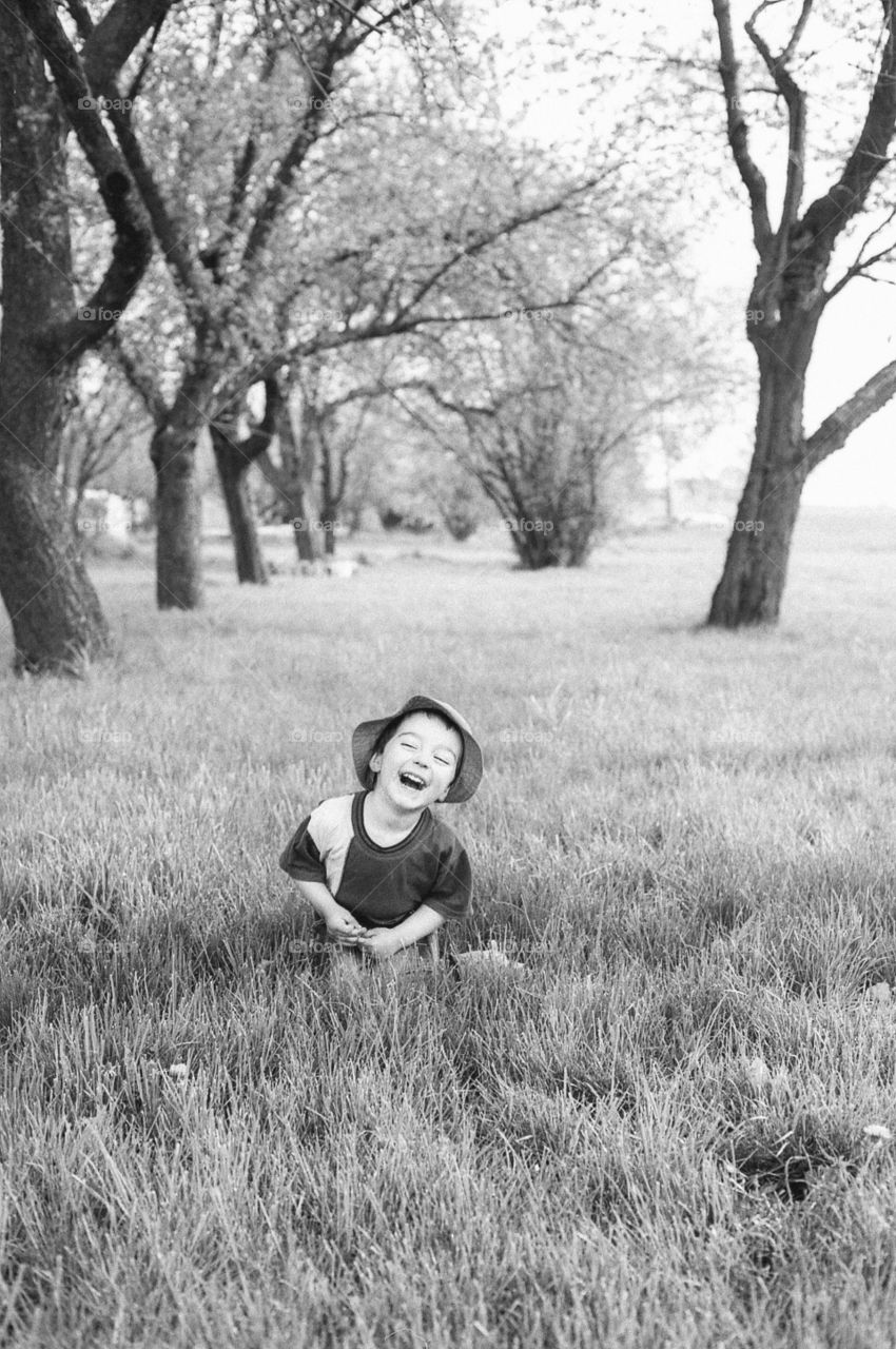 Smiling boy standing in forest