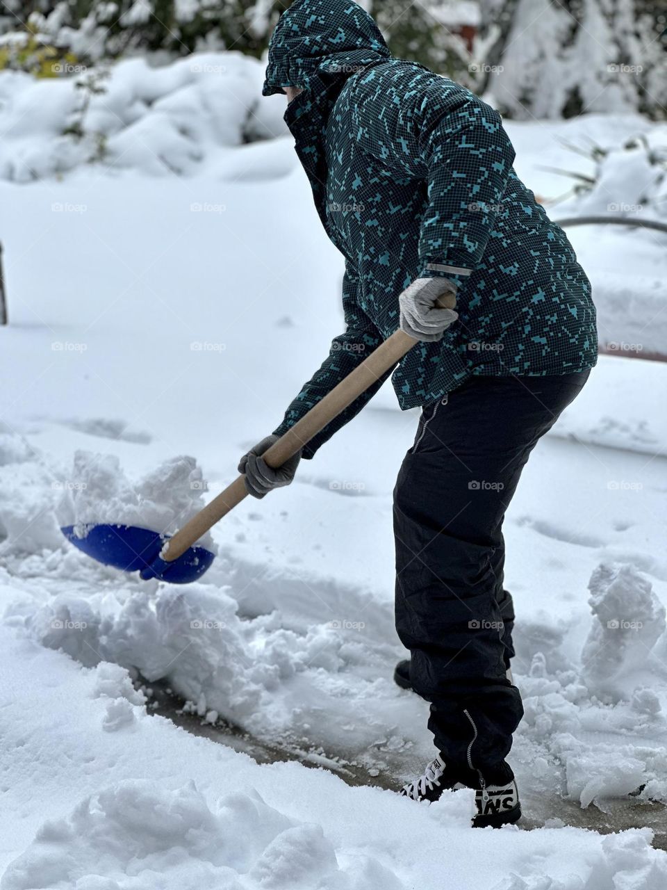 A man cleaning the snow with a shovel