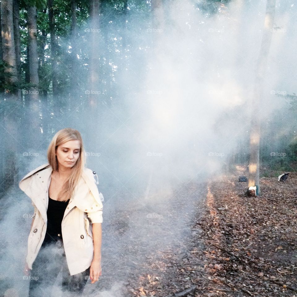 Beautiful girl in a smoggy Forest 