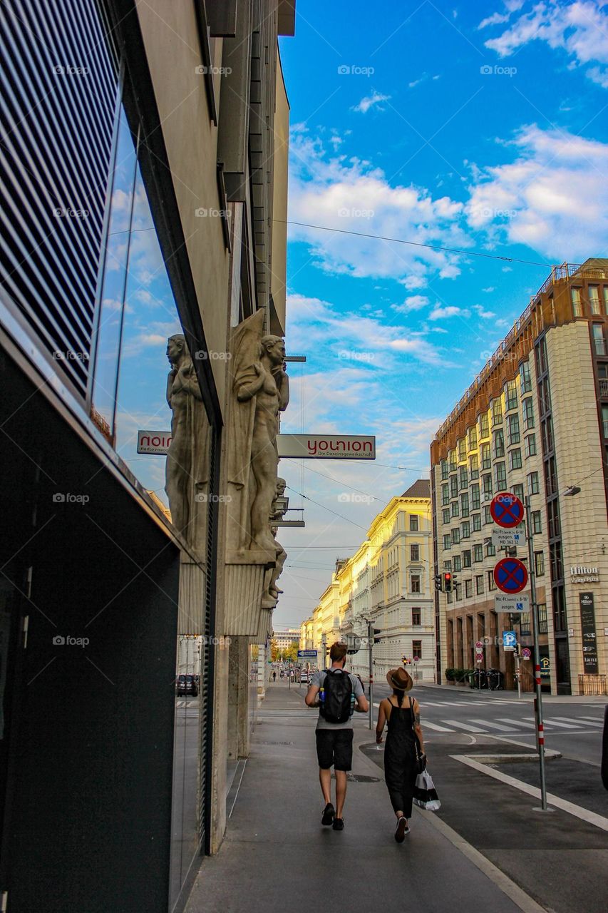 a walk on a city street on a summer evening