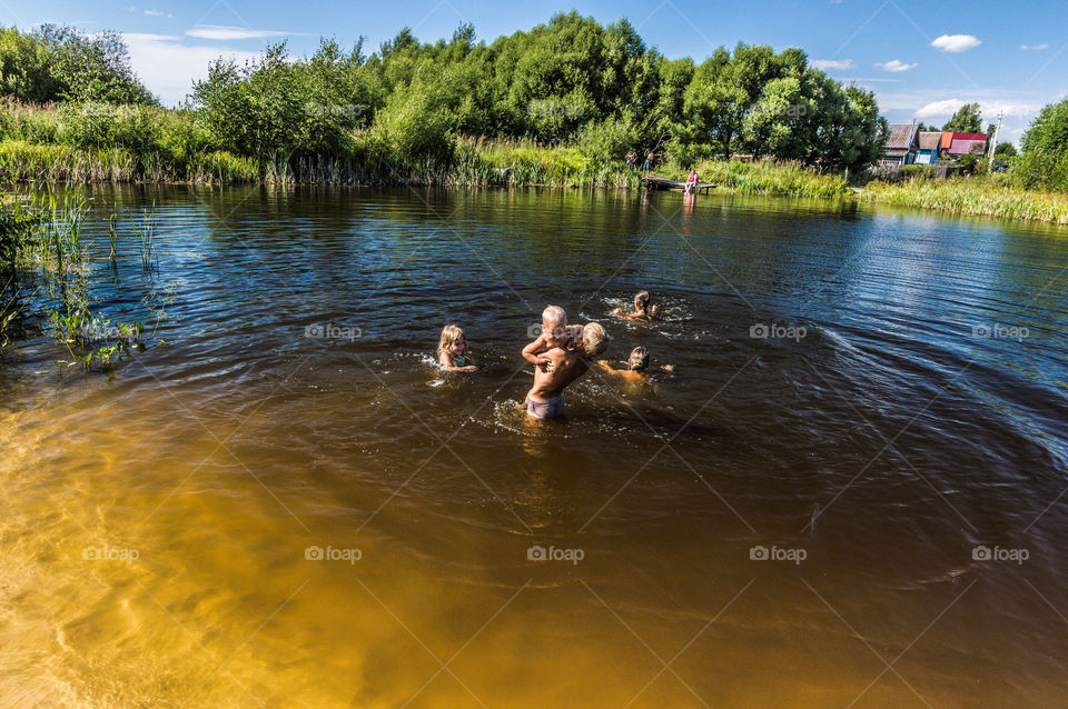Kids swimming in the lake