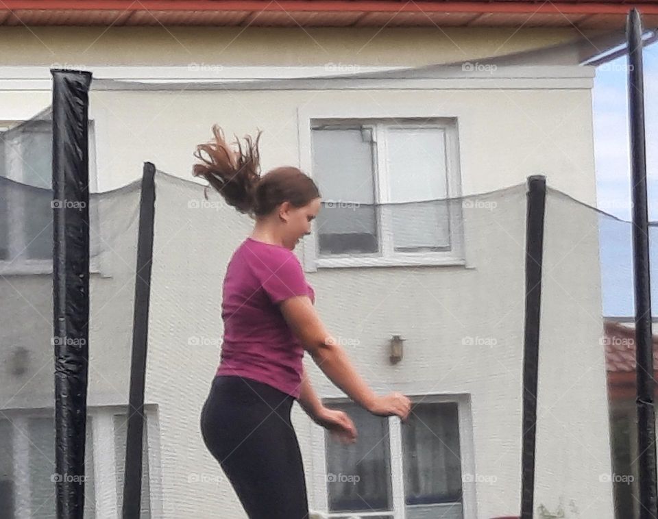 happy girl on garden trampoline