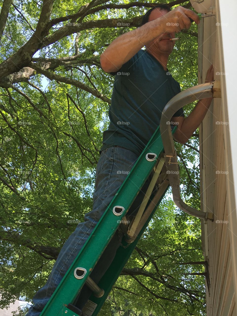 Installing surveillance camera on a house corner.