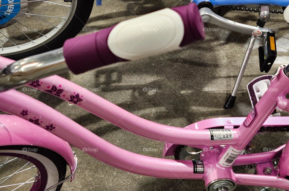 barbie style pink and purple bicycle handlebars with purple flower design for sale in an Oregon store