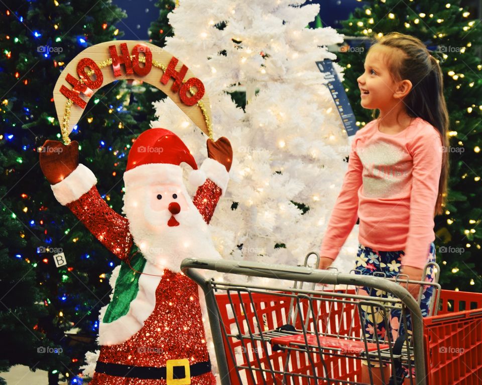 Smiling girl looking christmas decoration