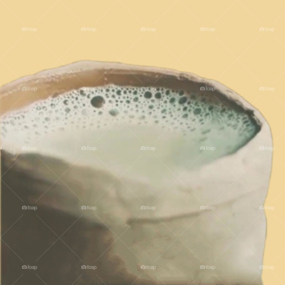 Drinking tea is being enjoyed in an earthen pot.