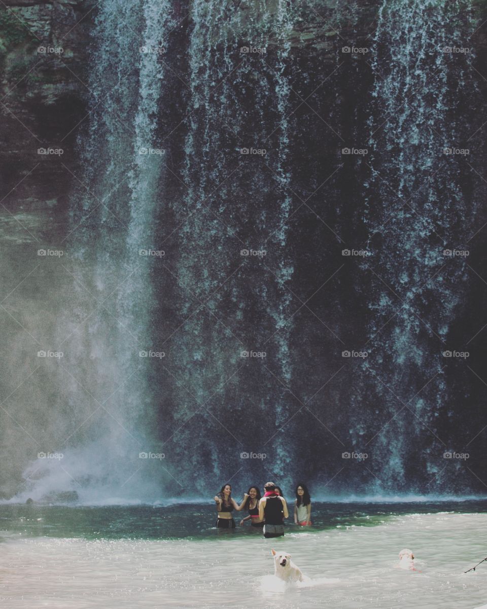 Playing under a waterfall