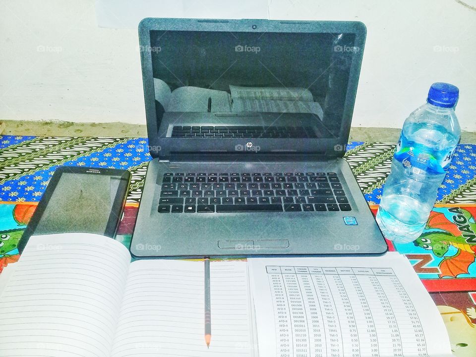 working tool:paper work,pencil,laptop,tab,drink in bottle