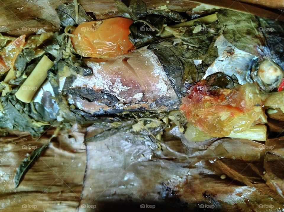 Steamed fish wrapped in leaves