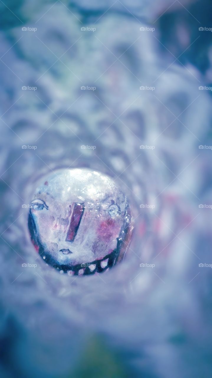 Painted face on glass.