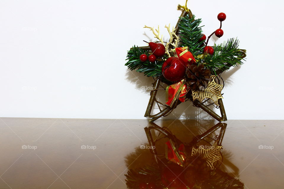Christmas wooden star with decorations on a wooden table