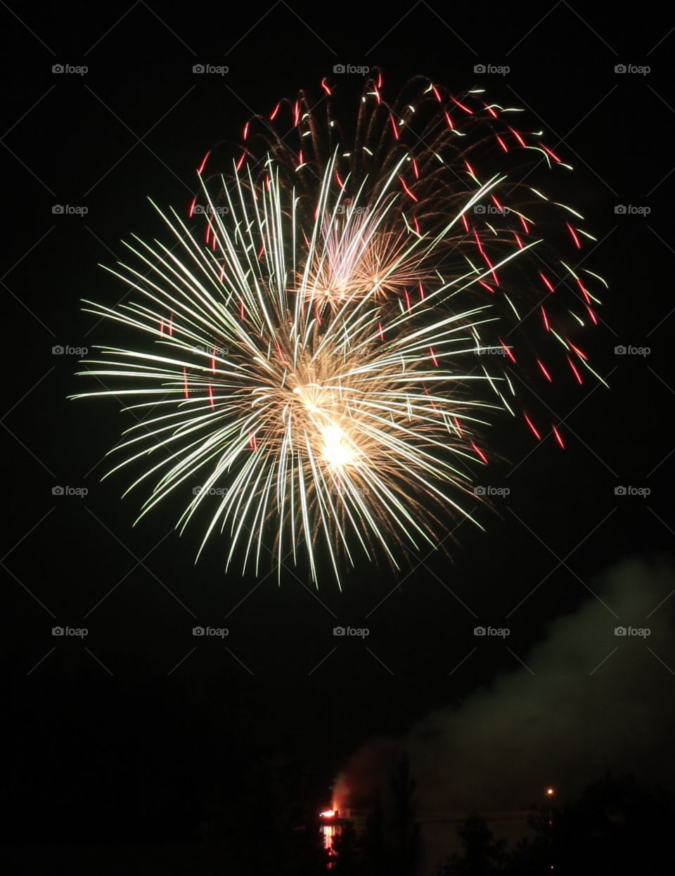 Yellow, white, red and green firework blast