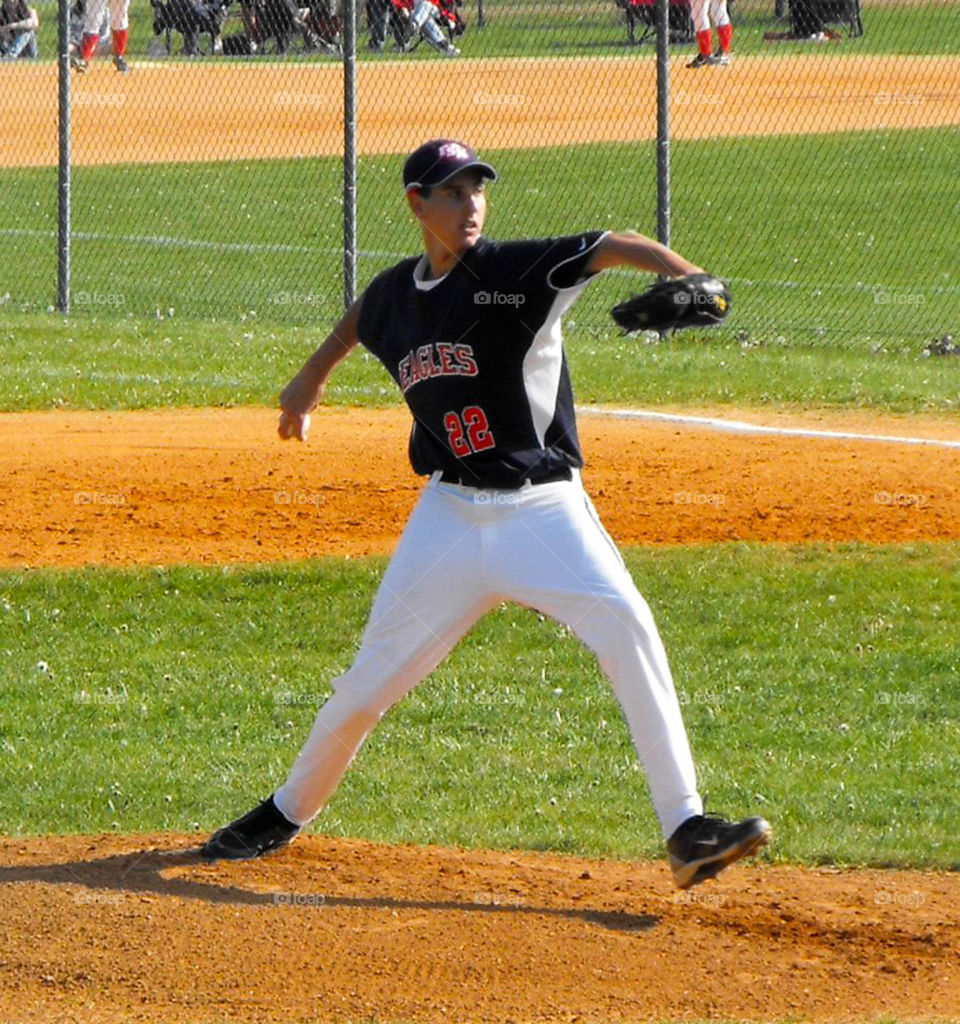 pitcher winding up. High School pitcher winding up on the mound