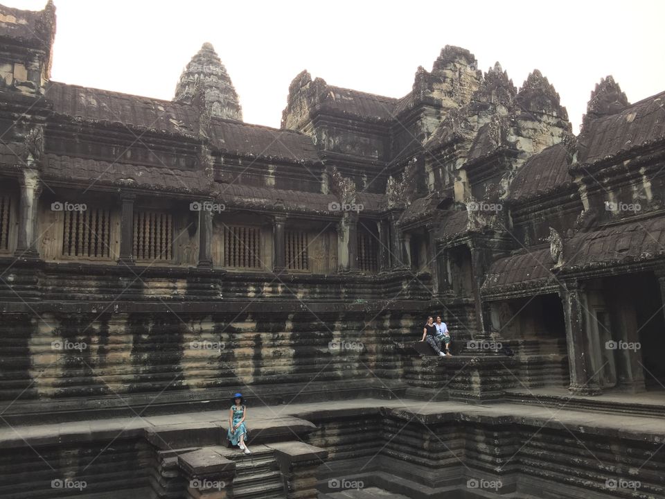 Stone buildings part of the ancient temple, Angkor Wat in Cambodia. Old architecture shows the beauty of nature. 