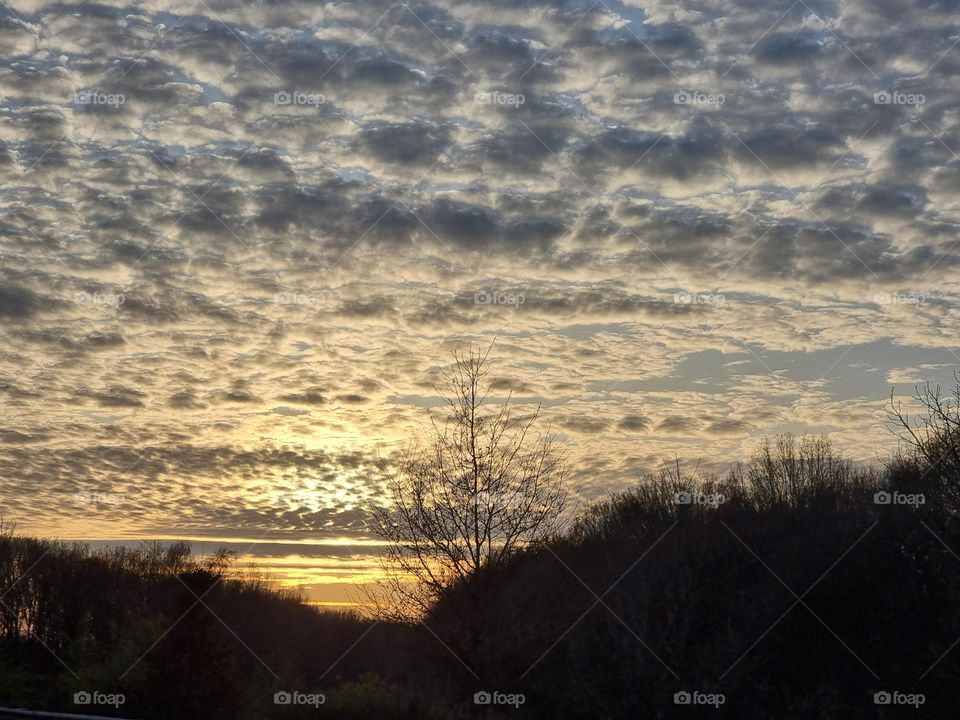 Beautiful colorful sunset with many small clouds in the sky