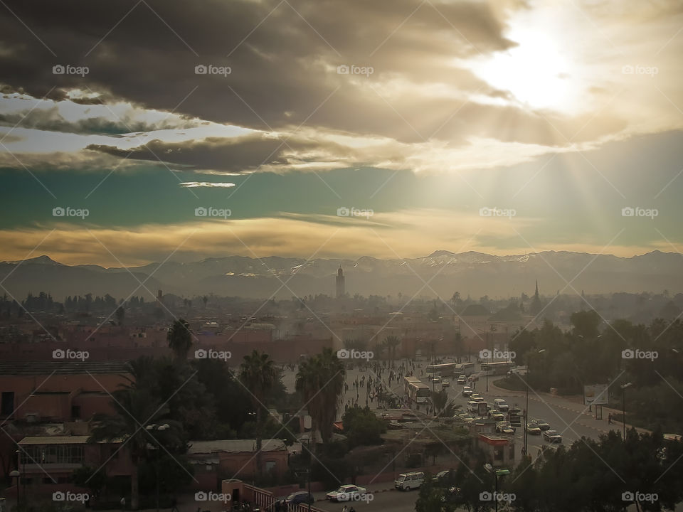 Winter sunset over Marrakesh with visible smog over the downtown and busy streets. Morocco.