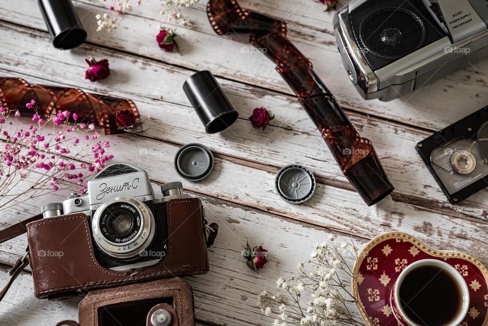 flat lay on wooden background old cameras film and tape recorder with cassettes