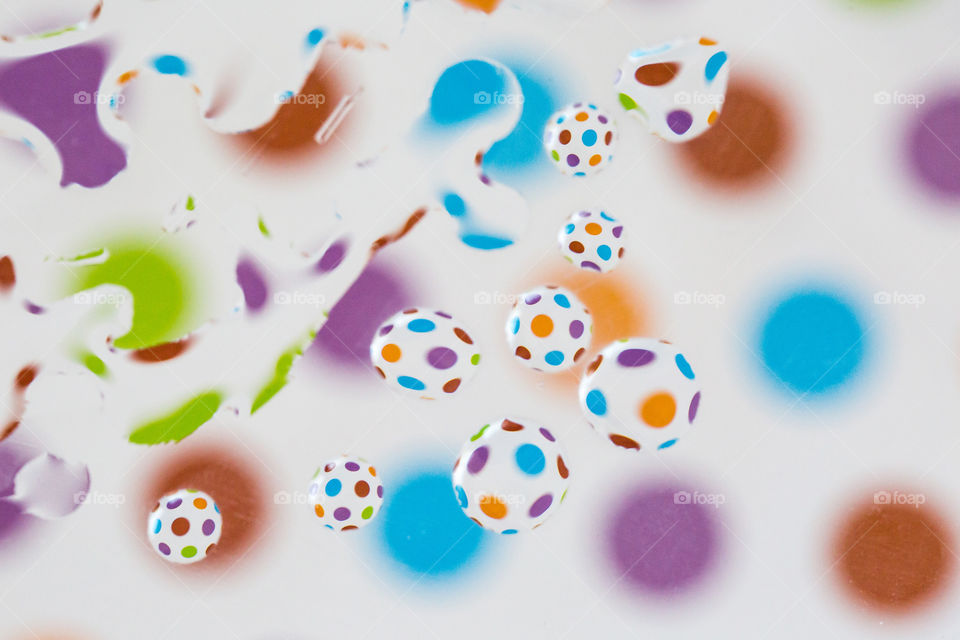 Shapes circles and ellipses using bright colorful circle background and many water drops reflecting the shape. Watercolour effect