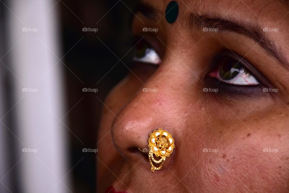 Indian woman wearing gold nose pin