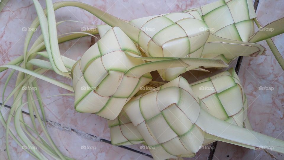 Making ketupat on the terrace of the house