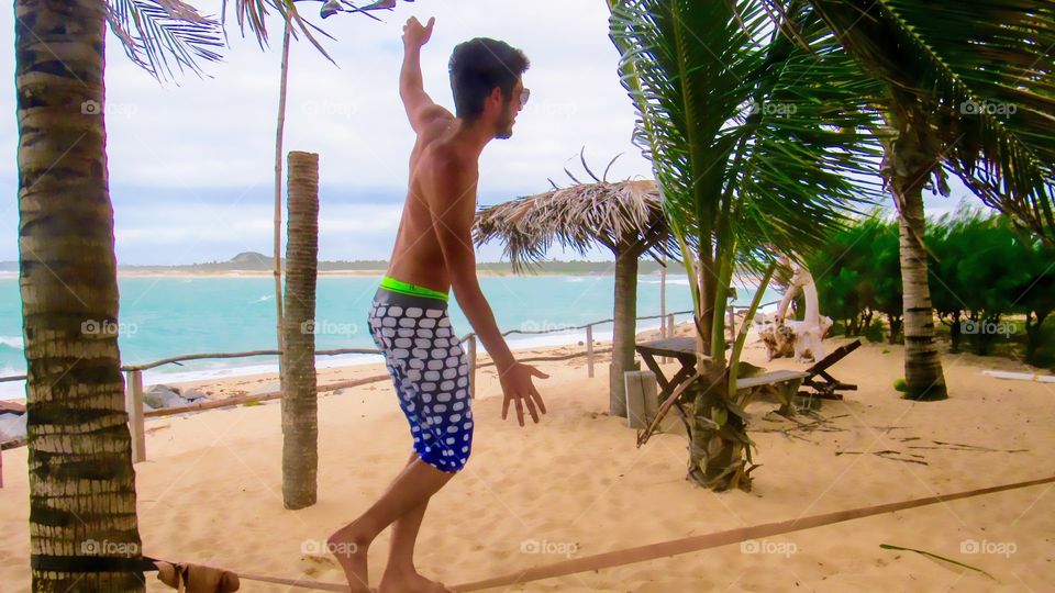 Boy practicing skyline at Pipa beach, RN Brazil