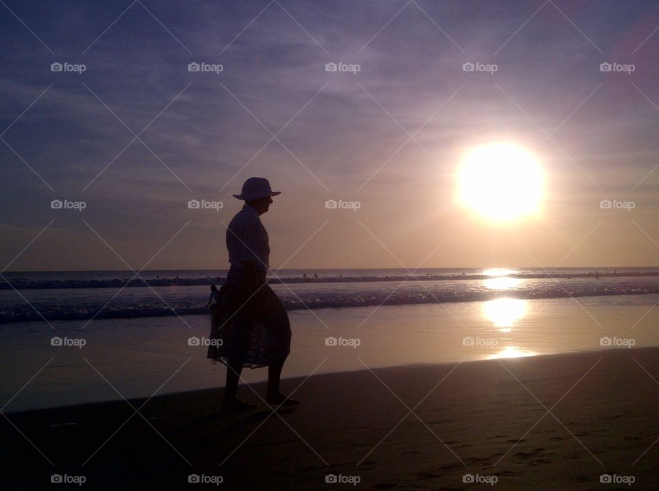Beach Walk. A lady walk at beach during sunset