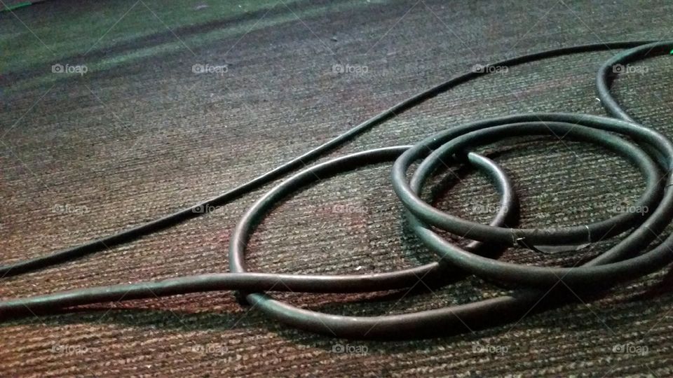 Cables laying on carpet.