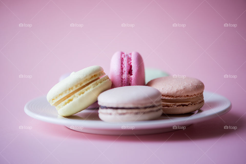 Pastel color macaroons on pink background