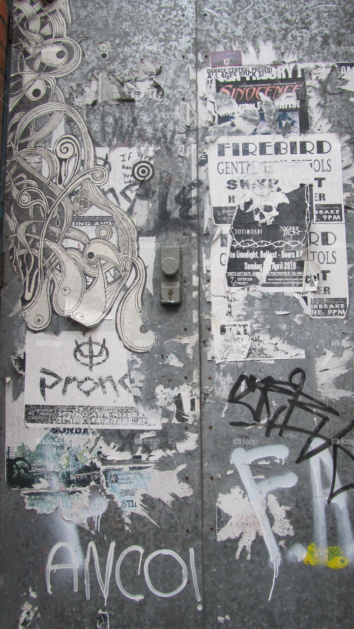 stickers on electric box. Layers of stickers on electrical box