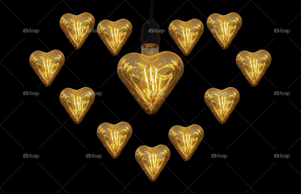 Isolated Orange bulbs at heart shape on a Black background with clipping path.