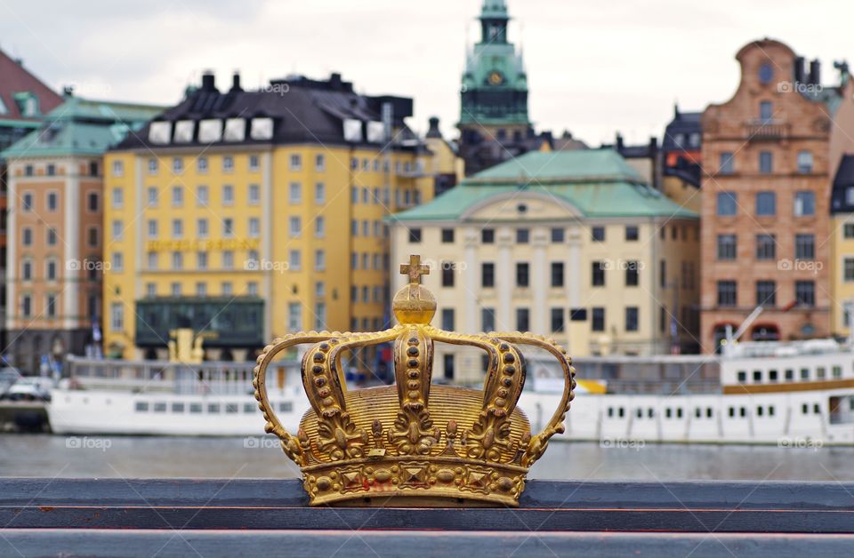 The gold crown on the skeppsholmen Bride with the old town background.  Autumn time in Stockholm Sweden.