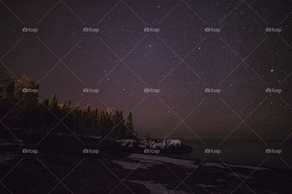 Starry sky on a clear winter night on Lake Superior. Grand Marais, Minnesota.