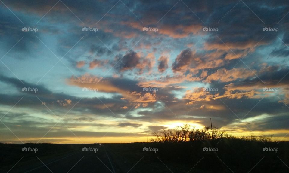 Sunset with vibrant blue, pink and golden sky.