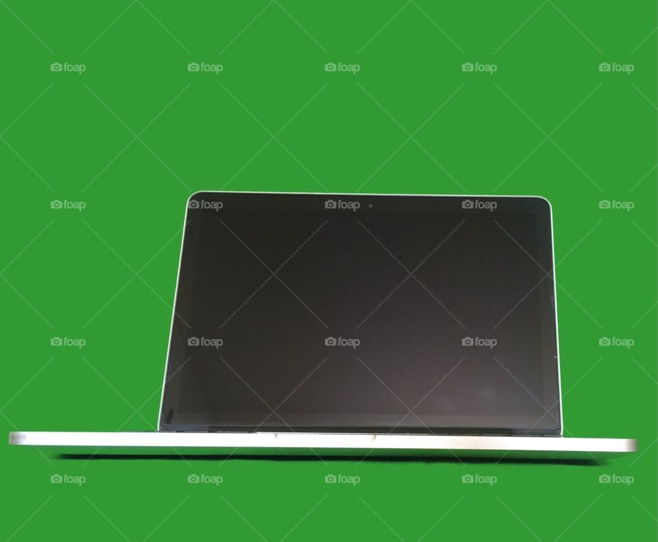MacBook Pro. Green screen behind
