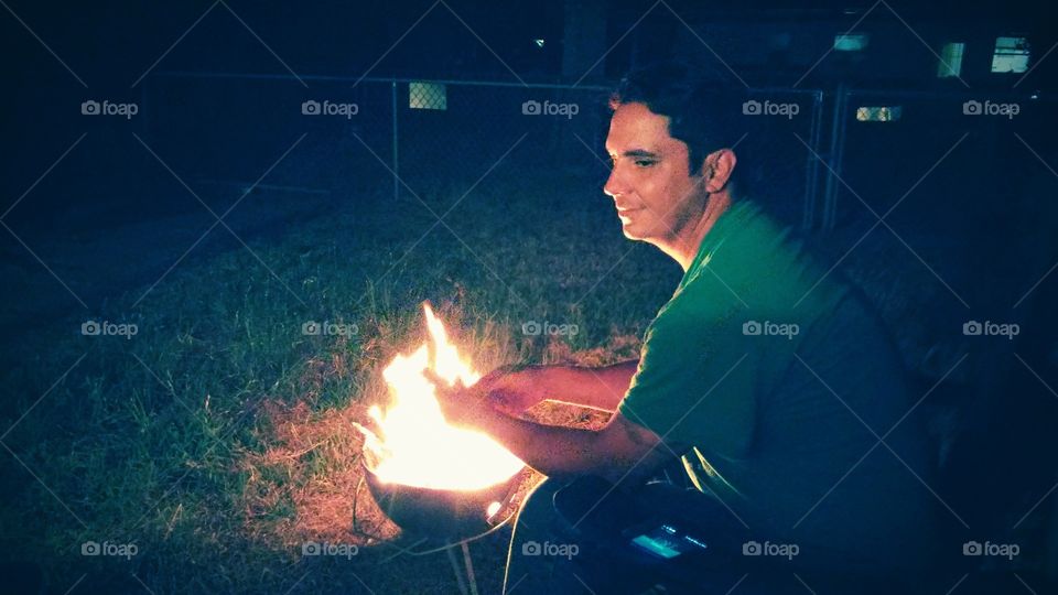 Man enjoying fire camp at night