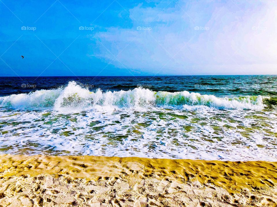 Beach with blue water and waves 