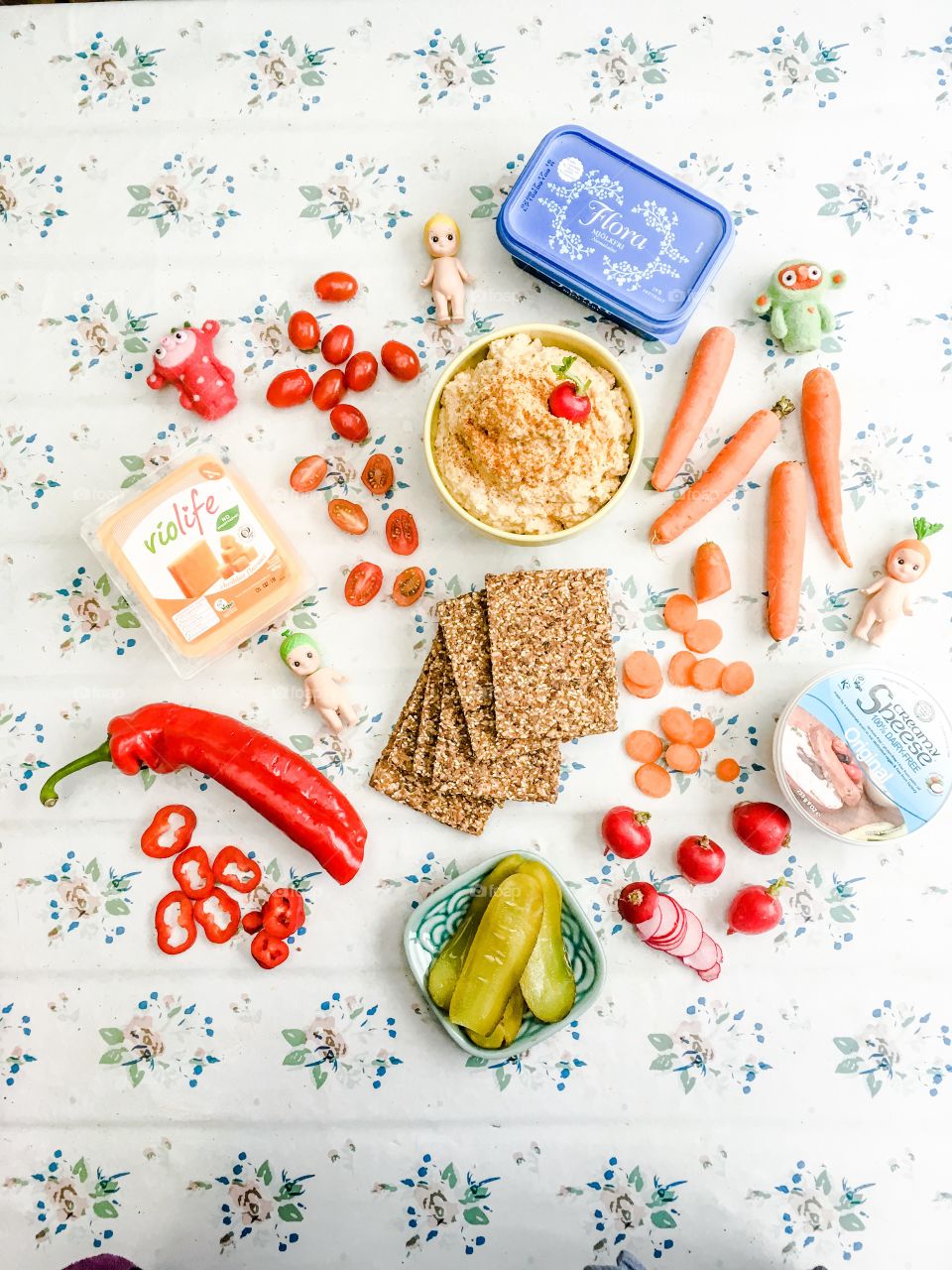 Healthy vegan snacks with plantbased toppings hummus veggies and dairyfree cheese