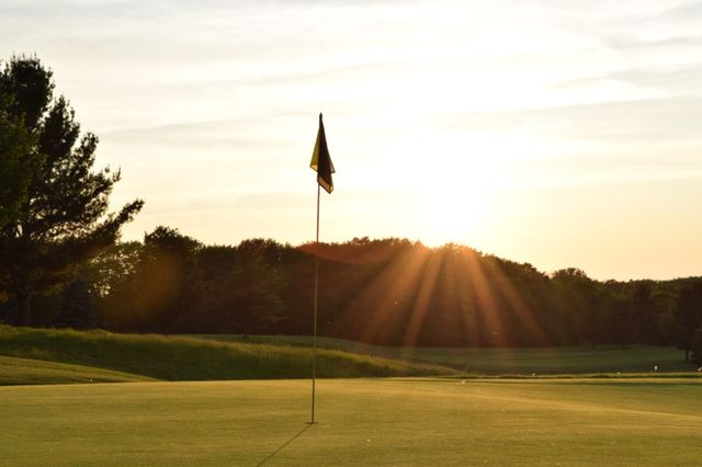 17th green at Sugarloaf . Sunset in the background if the flag pin on the 17th green at Sugarloaf the Old Course in Leelanau County's, MI