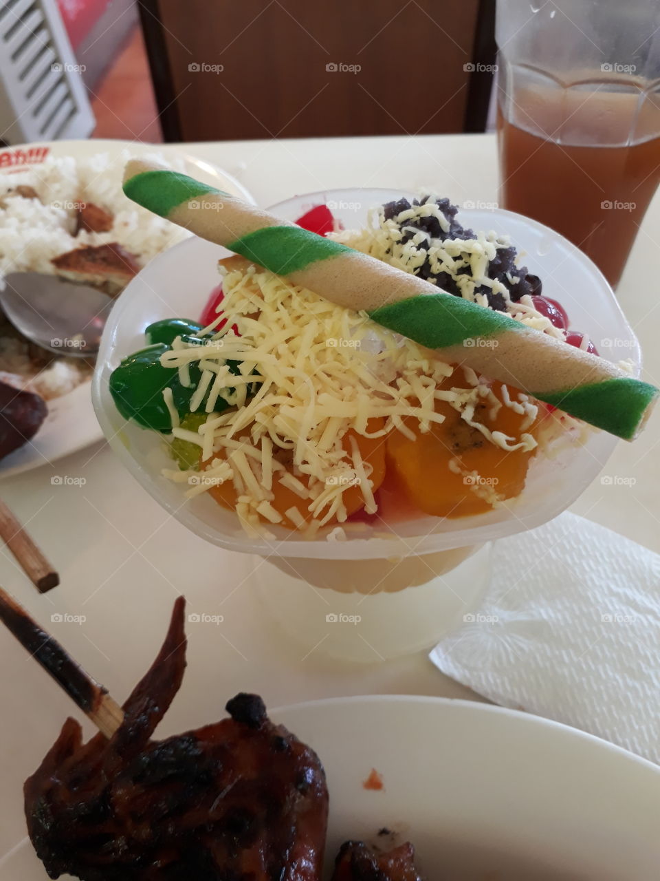 Halo-halo (Filipino Dessert) a mixture of shaved ice and evaporated milk to which various ingredients are added, including boiled sweet beans, coconut, sago, gulaman, tubers, fruits and yam ice cream