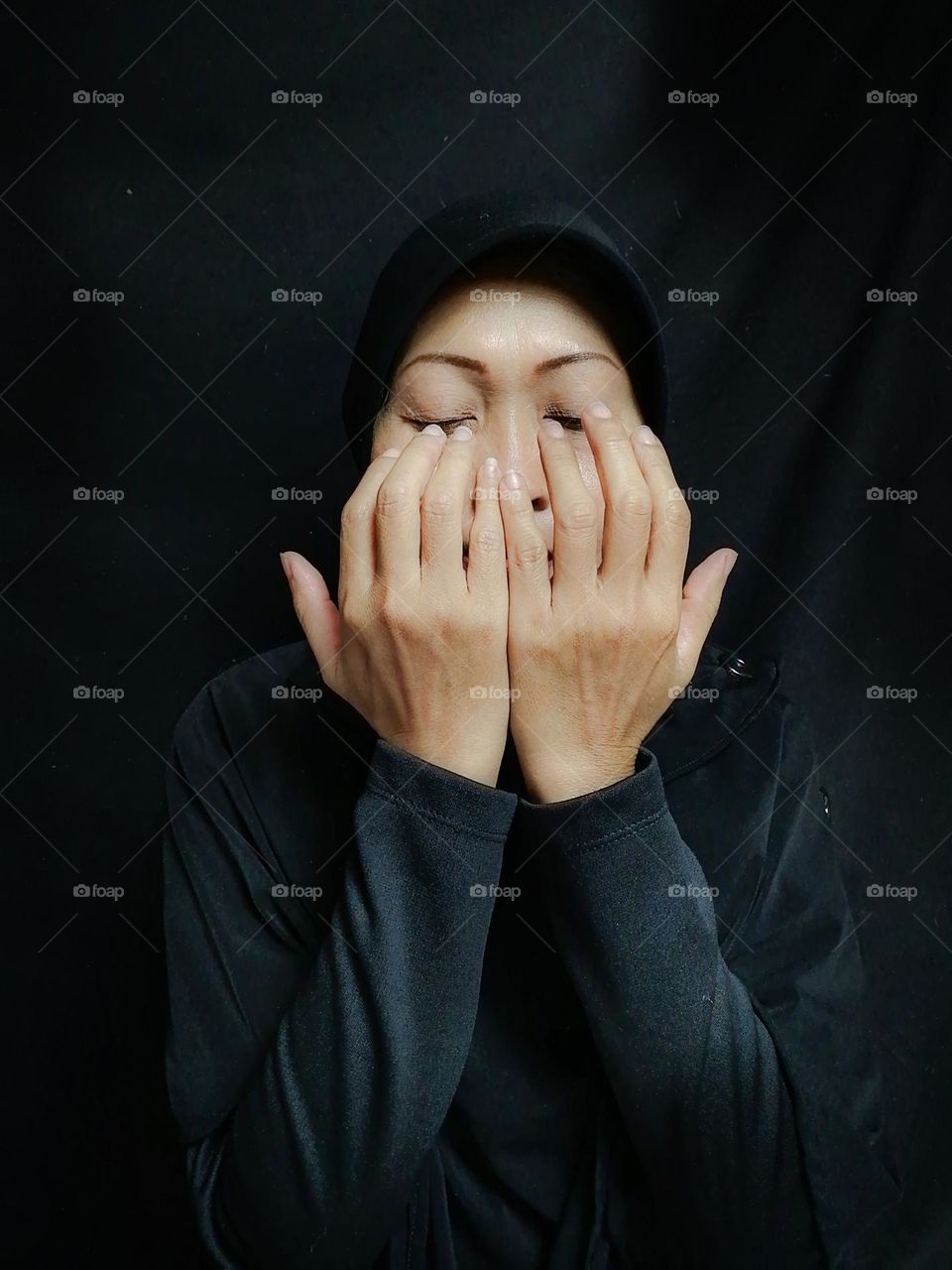 Praying on black background