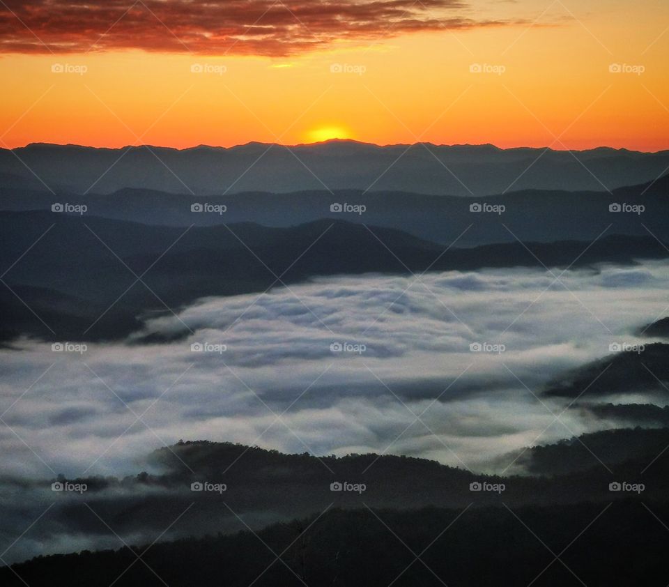 One minute before dawn. Clouds were forming in the valley below. Photo taken on Doi Samer Dao in Nan, Thailand.