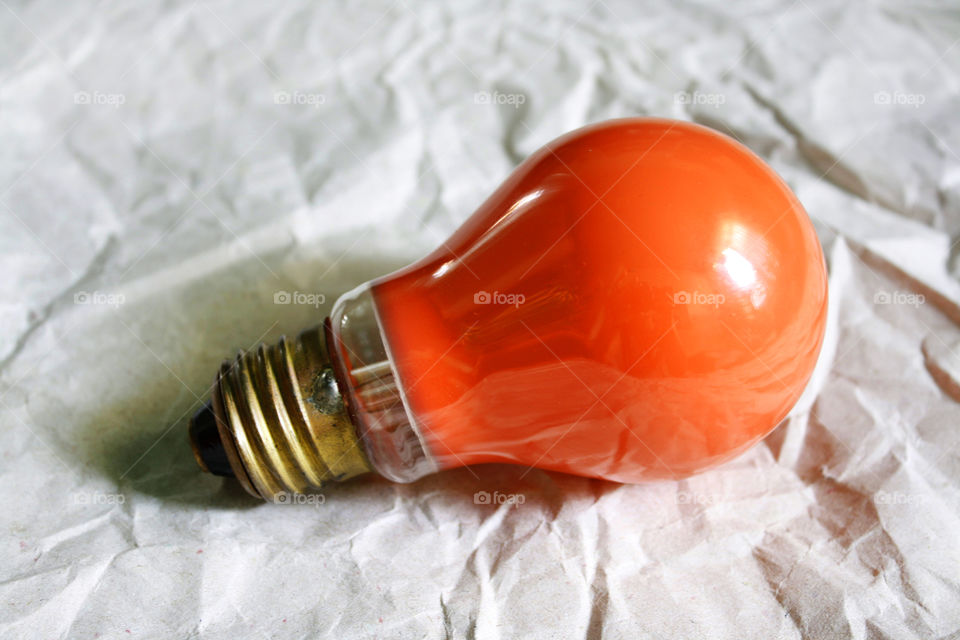 An orange bulb on a paper background 2