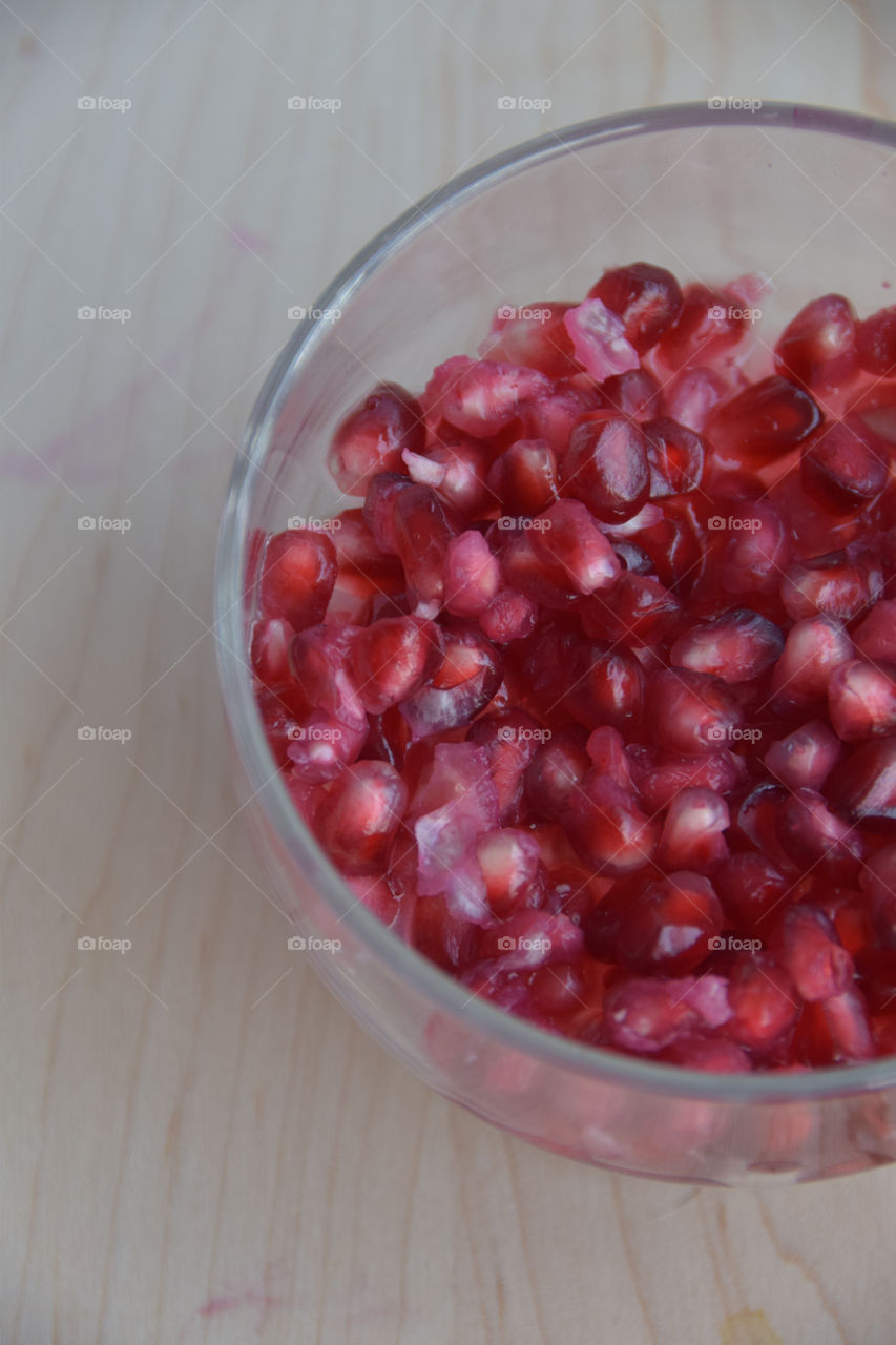 Healthy organic pomegranate superfood seeds in a glass bowl