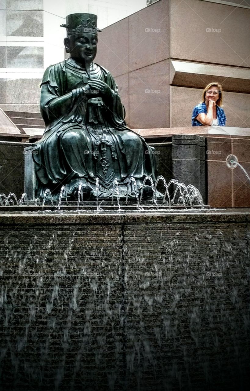 Woman standing near statue