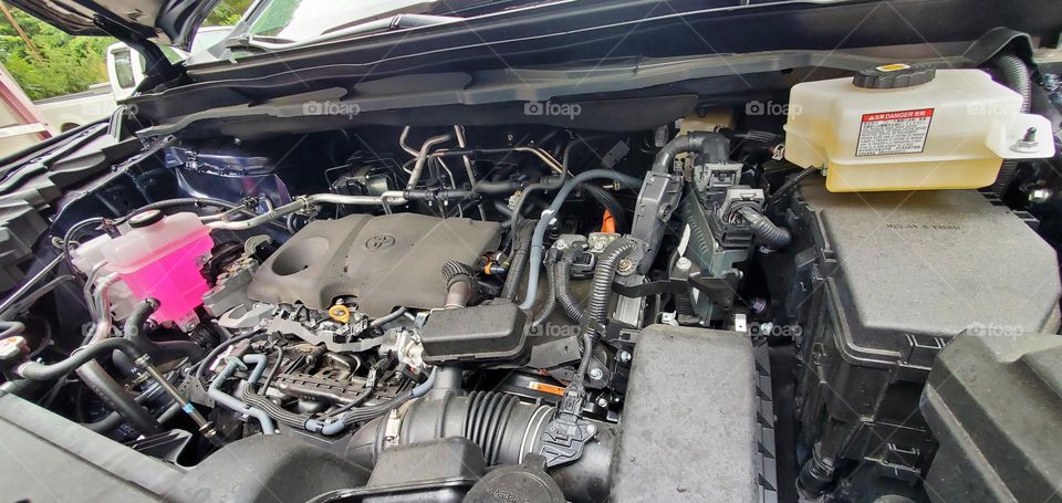 under the hood of a 2023 Toyota Sienna Hybrid we see what makes it run & the pink windshield washer fluid