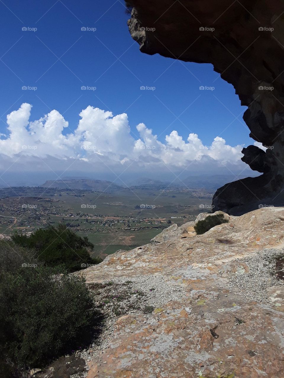 A view of the mountain from distance, with cloudy skies at summertime.