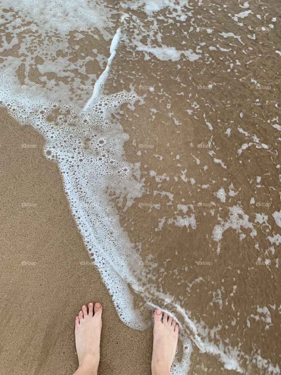 Toes in the water and toes on the sand