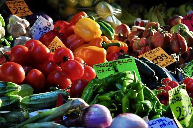 Fresh colorful organic assorted vegetable exposed at an Italian market stand with price tags 